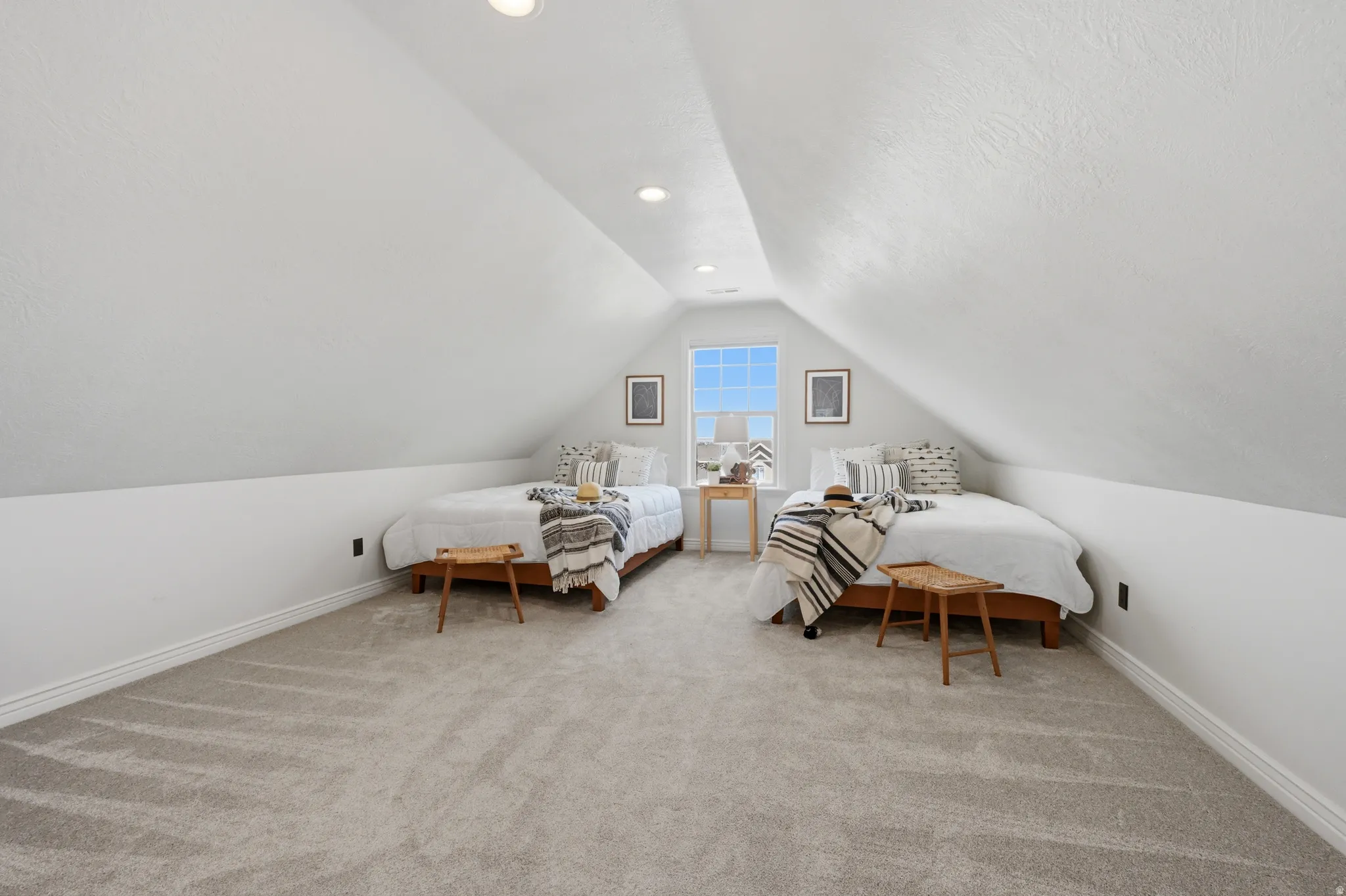Carpeted room featuring a centered window, vaulted ceilings, and recessed lighting