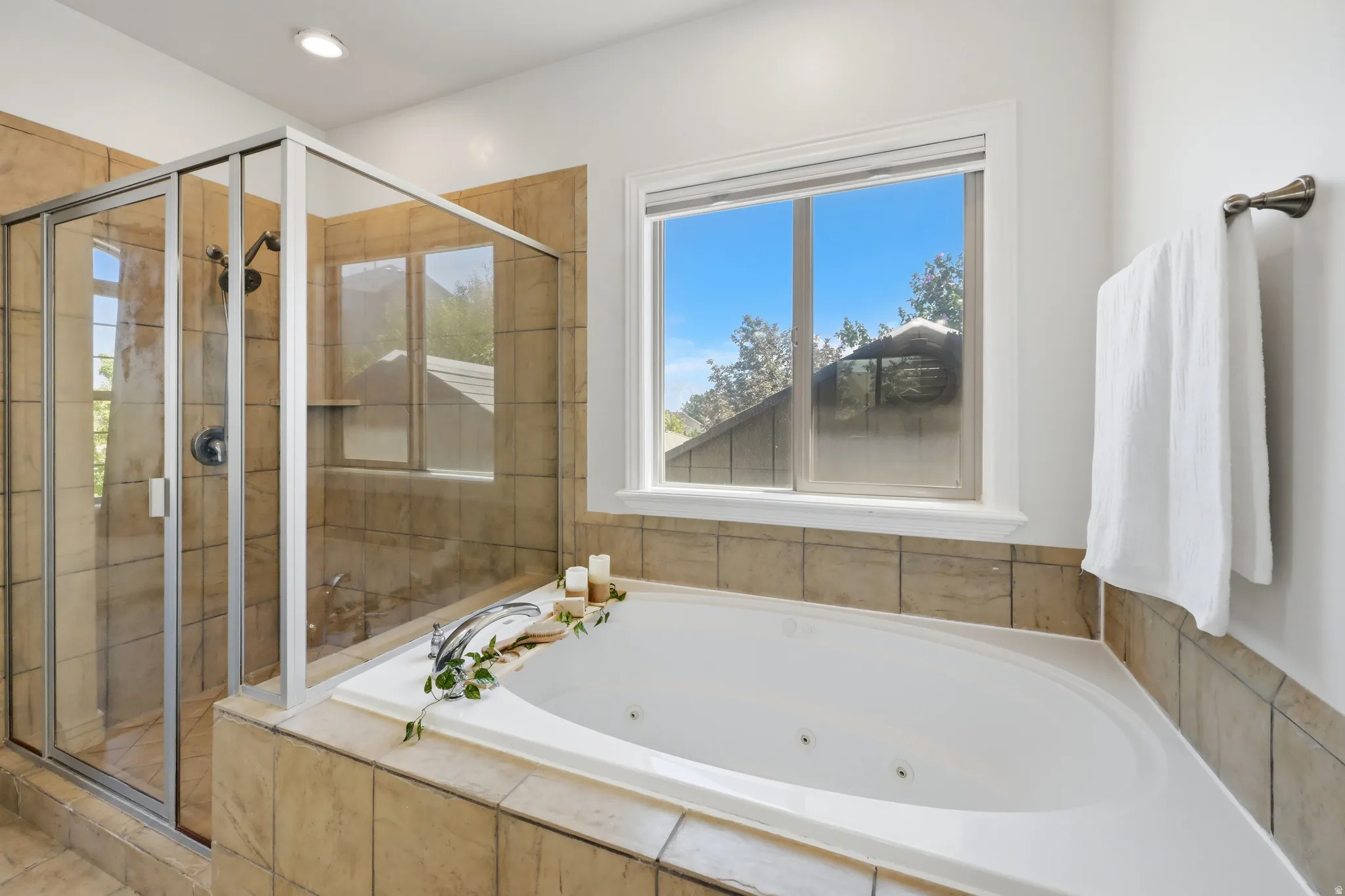 Integrated jetted soaking tub and glass-enclosed shower with tile surround