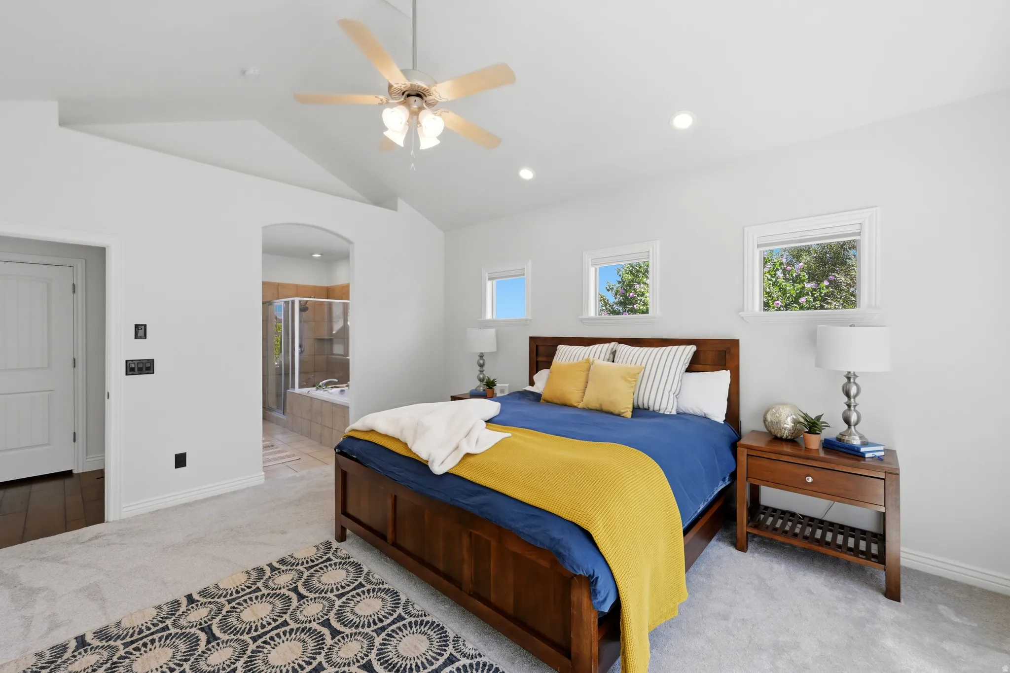 Vaulted ceilings with a ceiling fan and recessed lighting