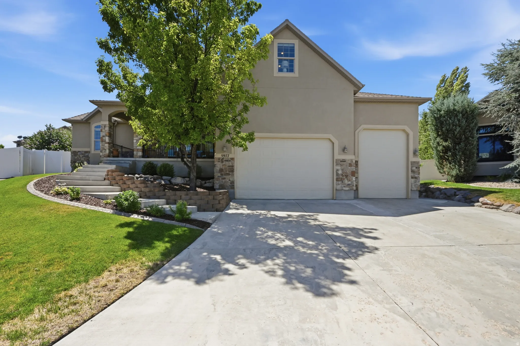 Stucco exterior with stone accents and a covered entry