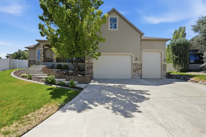 Stucco exterior with stone accents and a covered entry