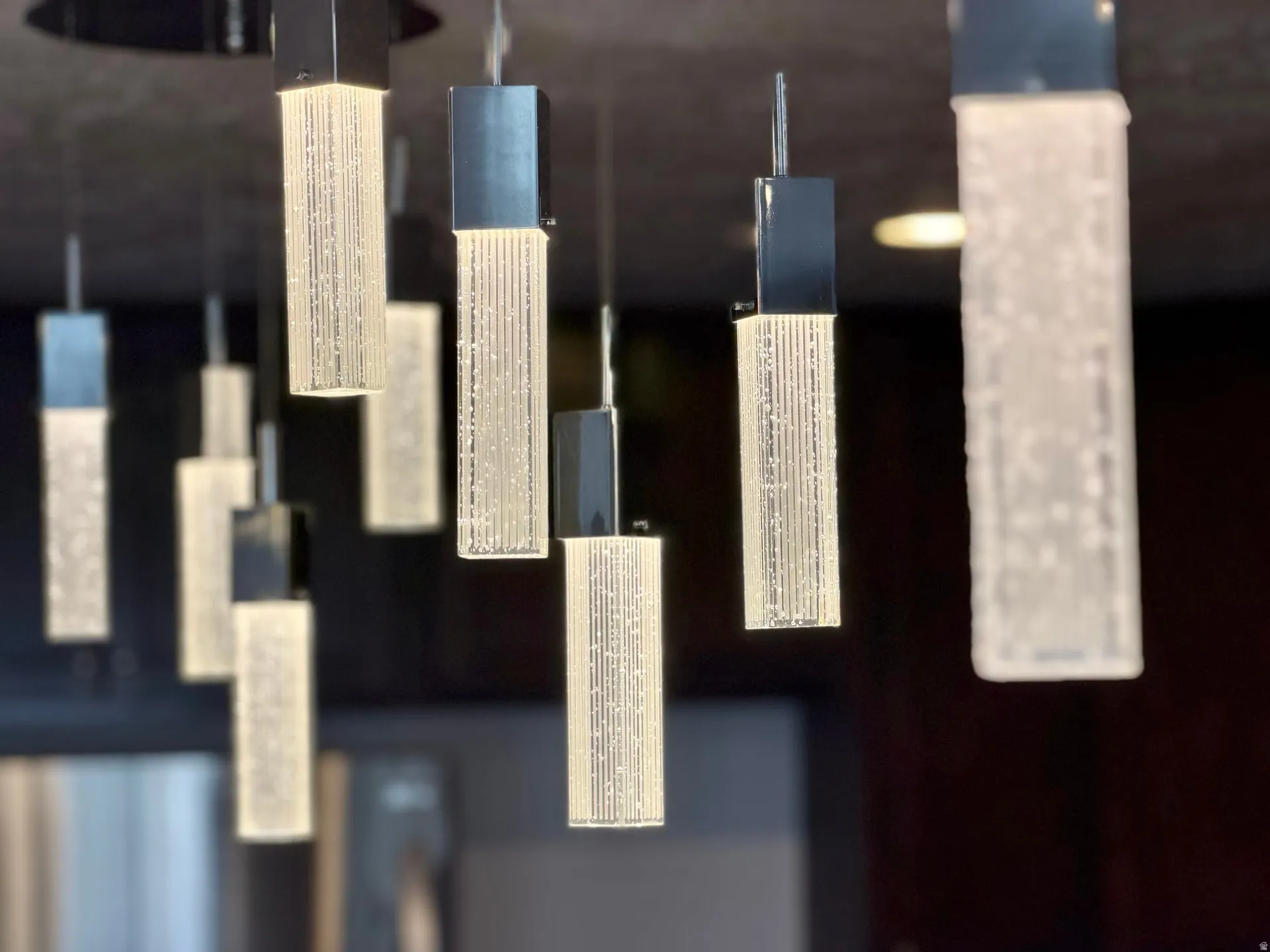Contemporary multi-pendant lighting fixture featuring rectangular frosted glass shades and polished chrome accents