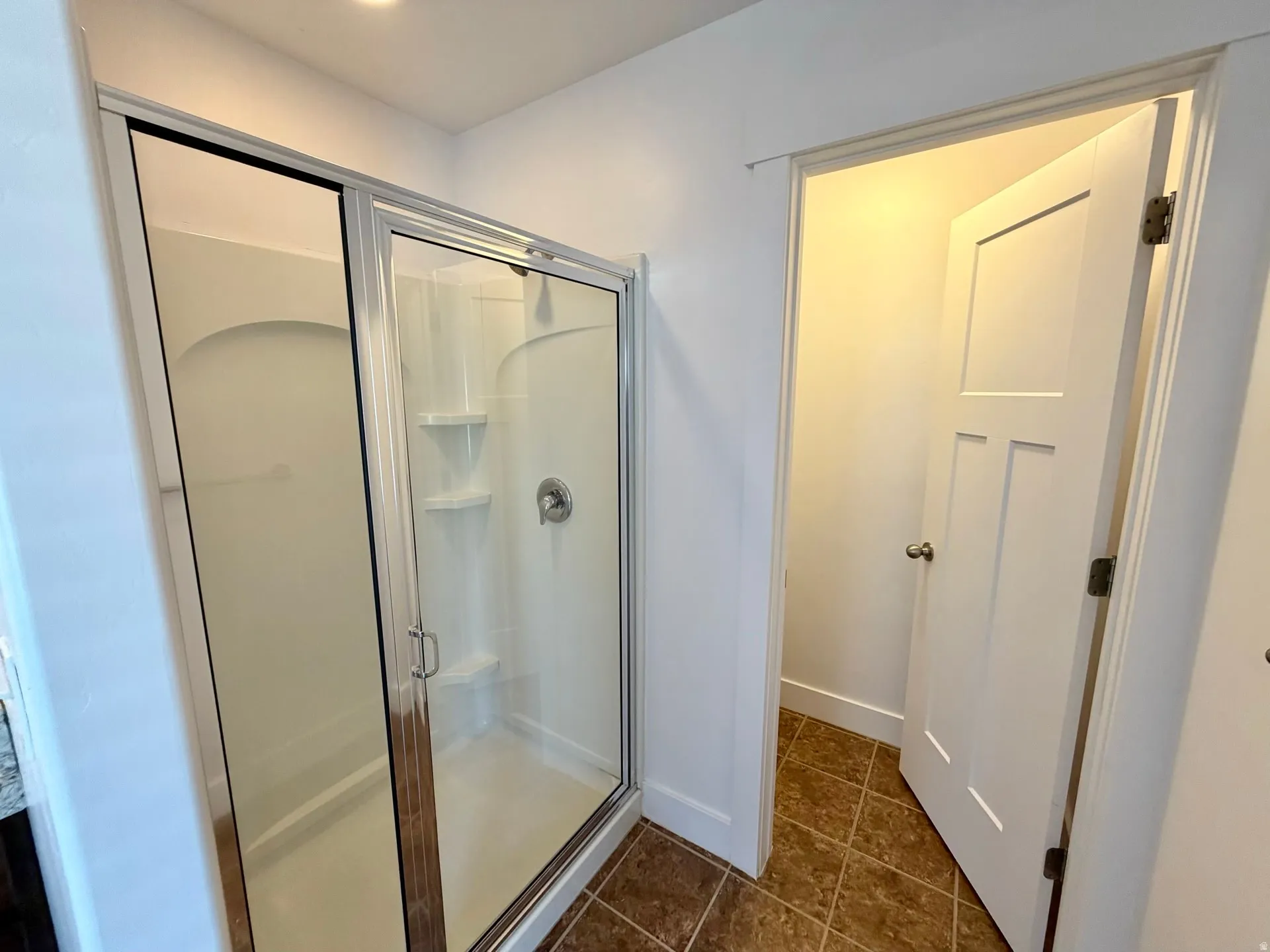 Shower enclosure with clear glass sliding doors and white composite interior