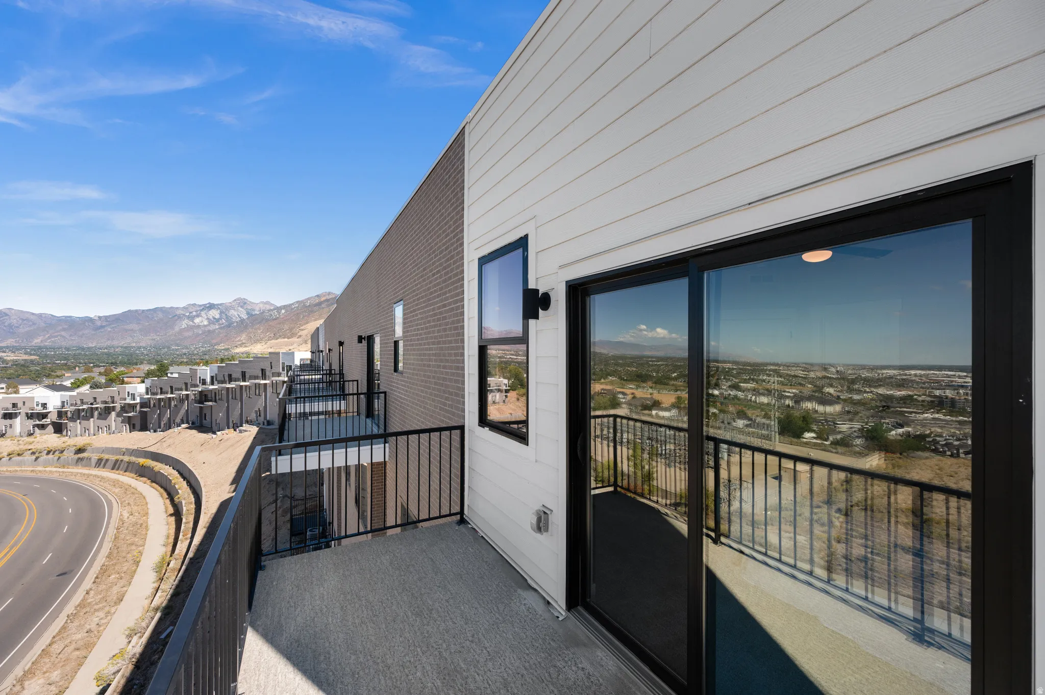 Private balcony featuring a sliding glass door and black metal railing
