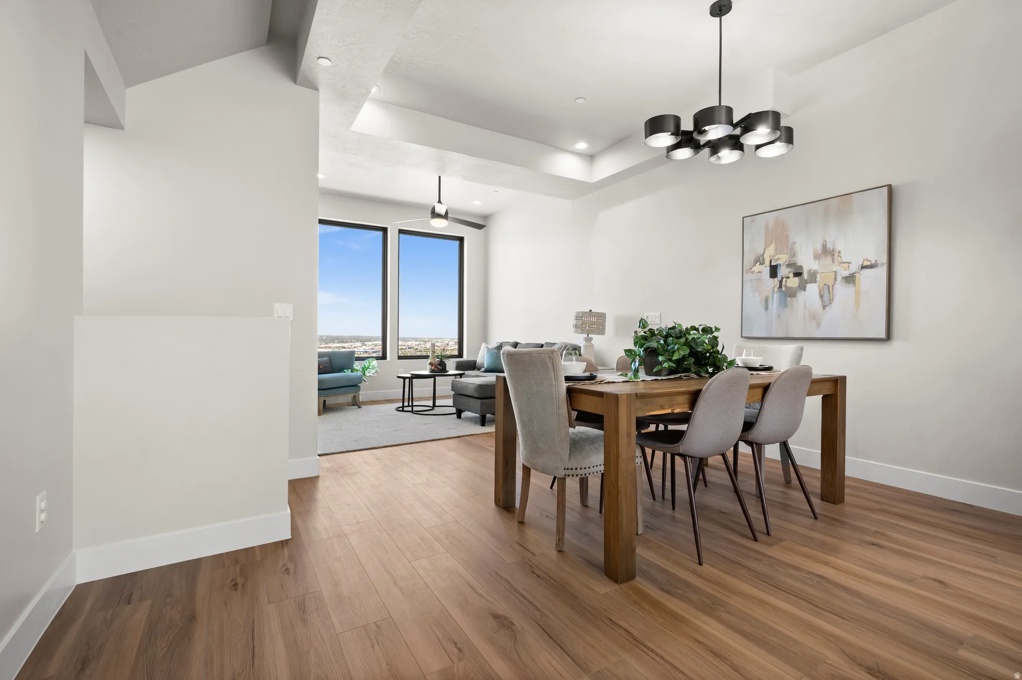 Spacious interior featuring wood-finish flooring, a contemporary black chandelier, and recessed lighting