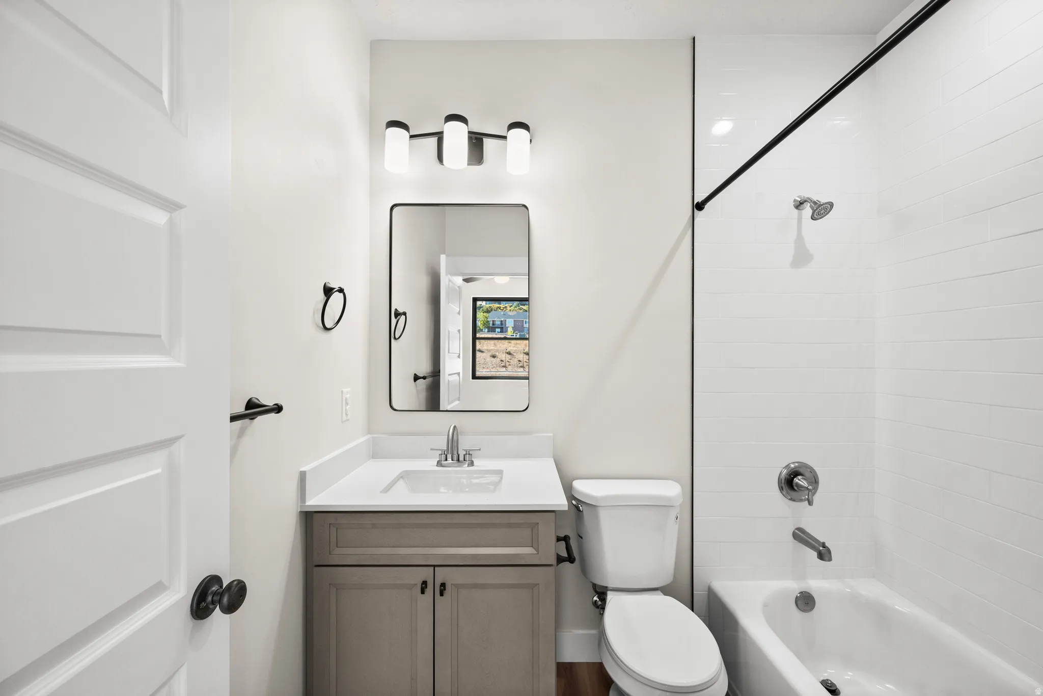 Bathroom featuring a light-toned vanity with a white countertop and rectangular sink
