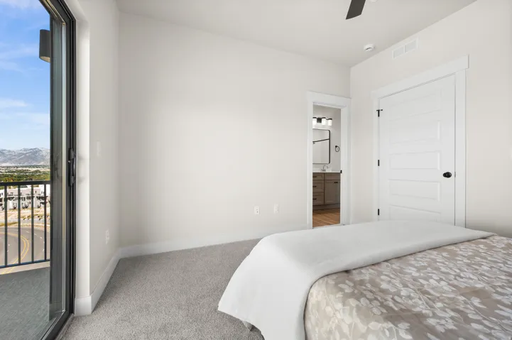 Interior room featuring a sliding glass door leading to a balcony with a black metal railing