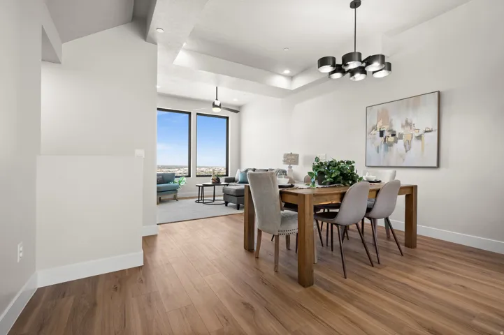Spacious interior featuring wood-finish flooring, a contemporary black chandelier, and recessed lighting