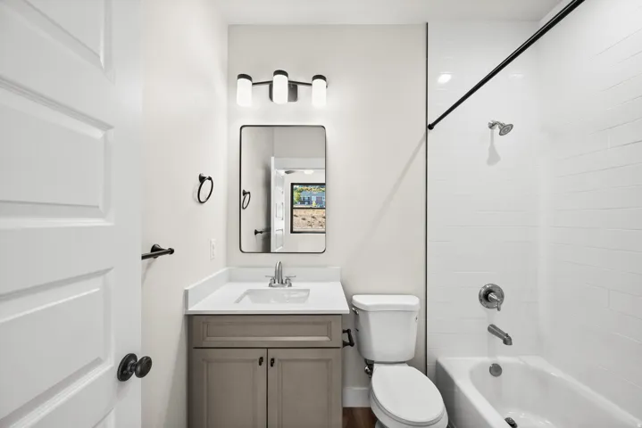 Bathroom featuring a light-toned vanity with a white countertop and rectangular sink
