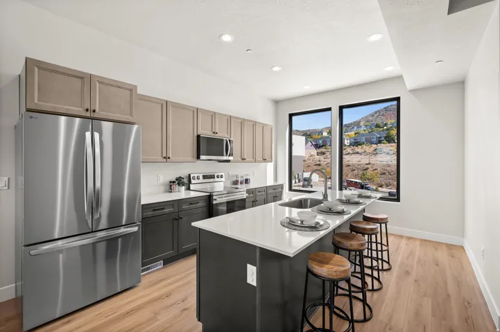 Kitchen featuring wood-finish flooring, recessed lighting, and a two-toned cabinetry scheme