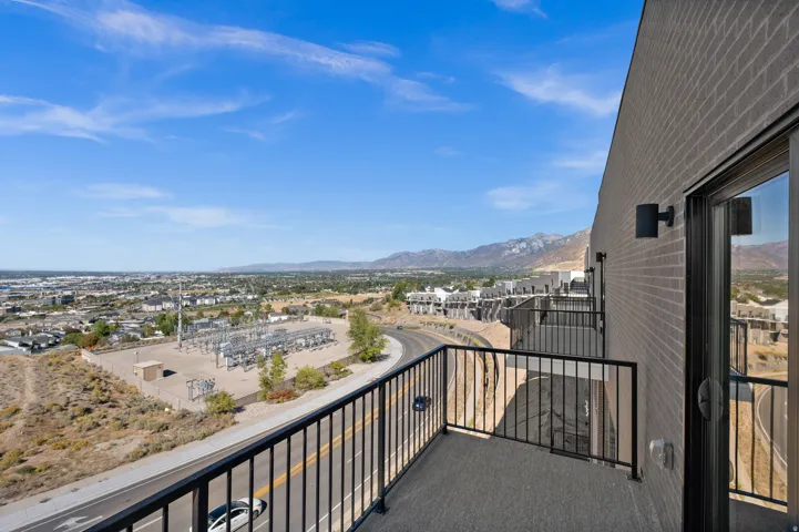 Private balcony featuring black metal railings and a textured floor