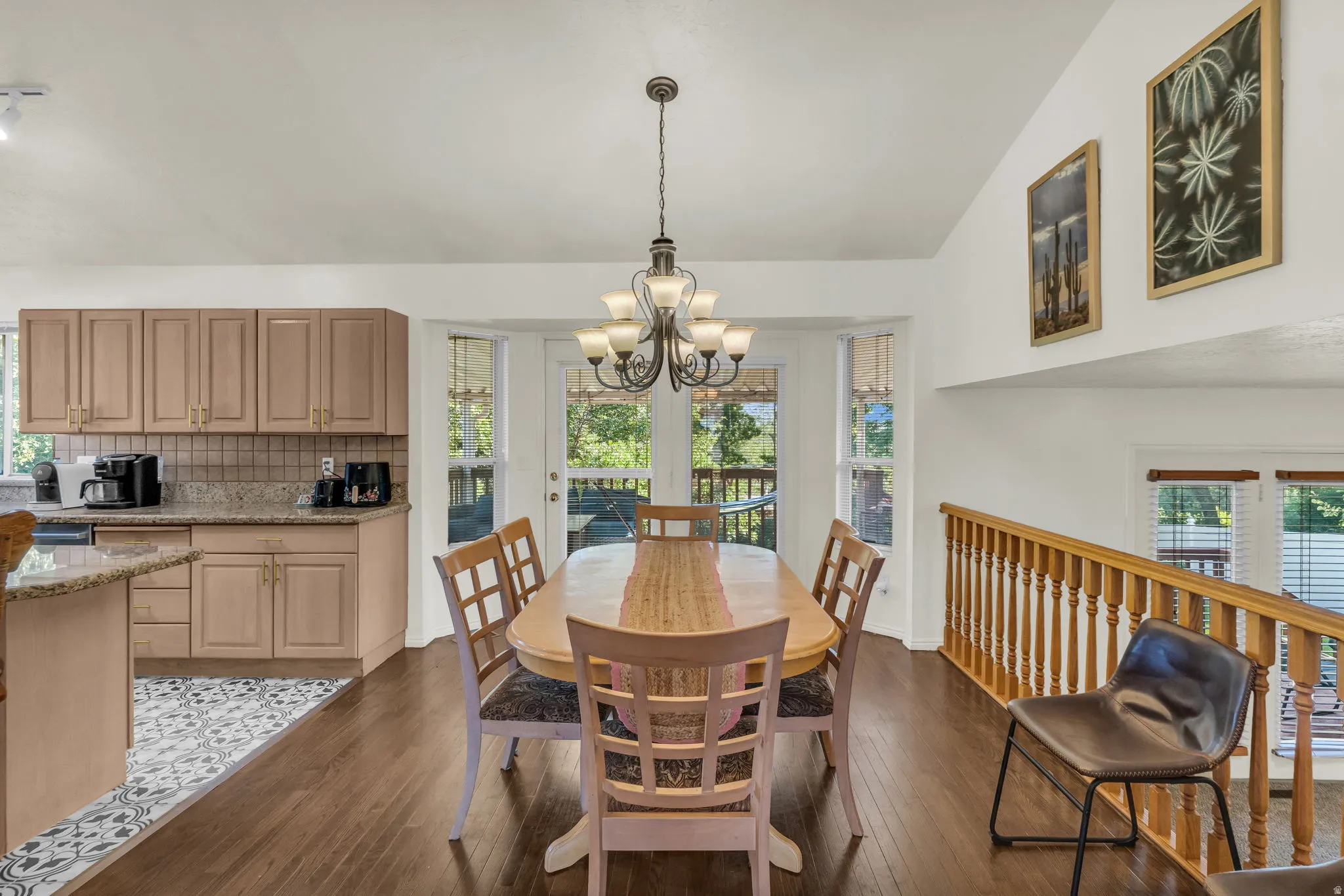 Dining area featuring a classic chandelier and wood-finish flooring