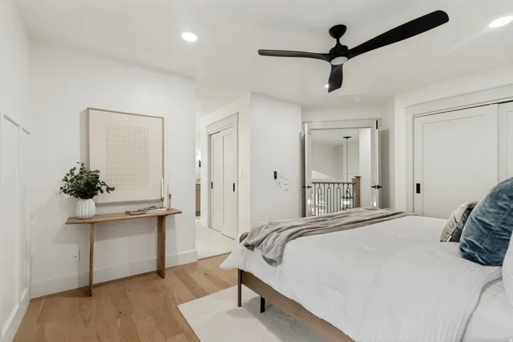 Bright bedroom space featuring light wood-finish flooring