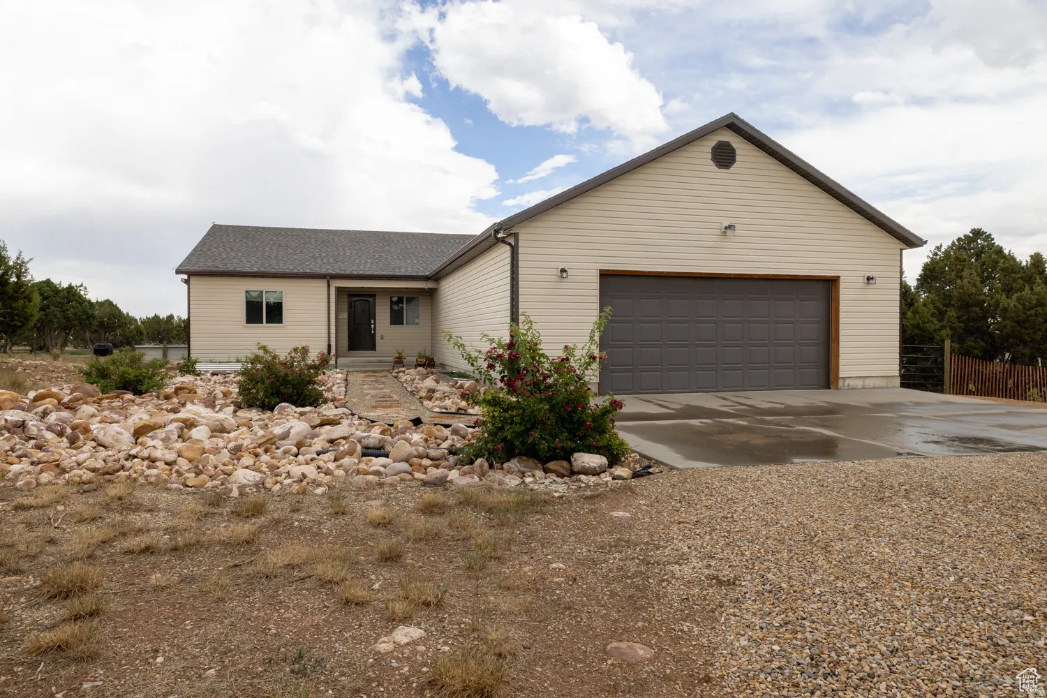Cream-colored siding exterior with a dark gray shingle roof