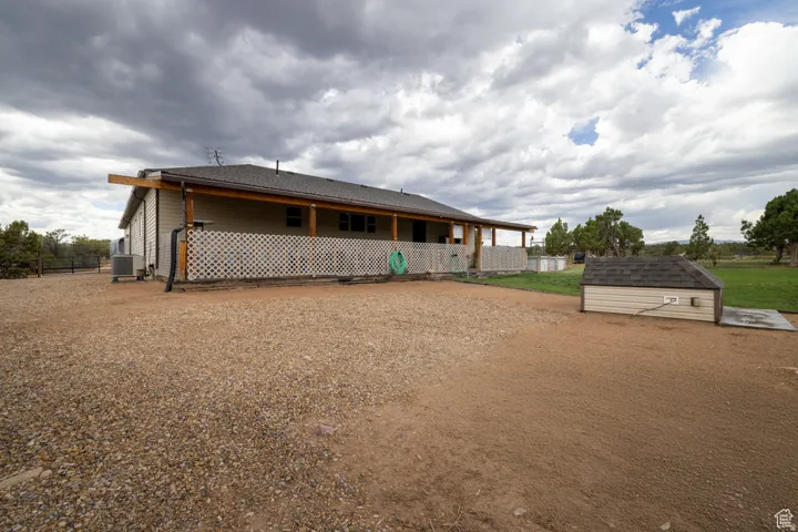 Ranch-style exterior featuring a covered porch, wood posts, and lattice railing