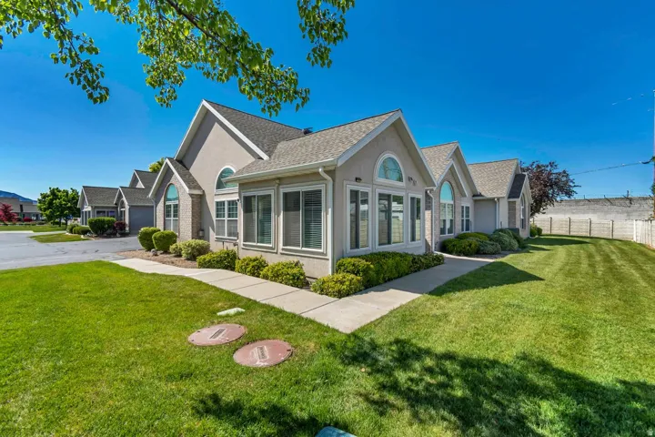 Contemporary stucco exterior with multiple gables and arched window accents