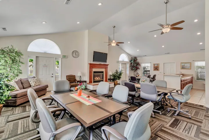 Spacious common area featuring vaulted ceilings, recessed lighting, and multiple ceiling fans