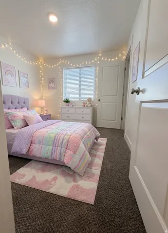 Recessed ceiling lighting, window with horizontal blinds, built-in closet with panel door, gray textured carpeting, and white trim.  AI version of the bedroom.