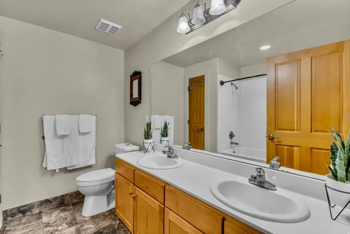 Master bathroom, double vanity, tub, and  linen closet.