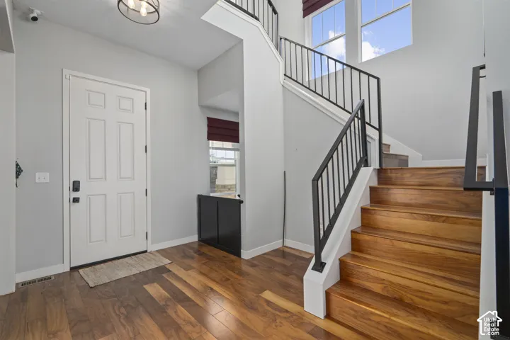 Wood-finish flooring throughout the entry and staircase