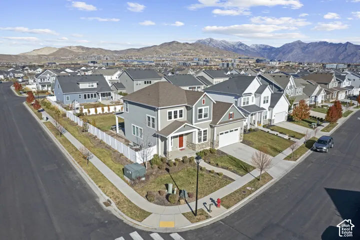 Corner lot property with a two-story exterior, attached garage, and a fenced backyard