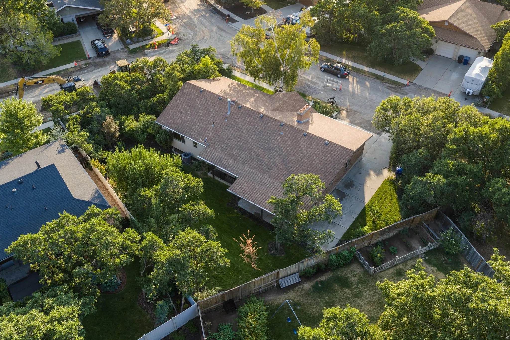 Residential property featuring a brown shingle roof and a concrete driveway