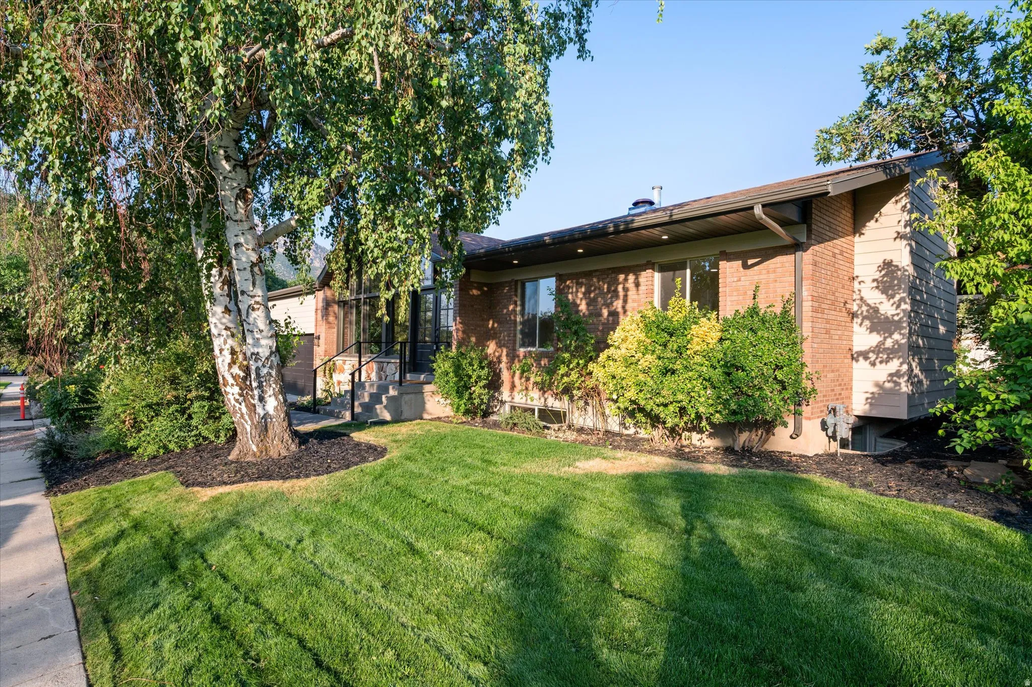 Brick and siding exterior with a pitched roofline