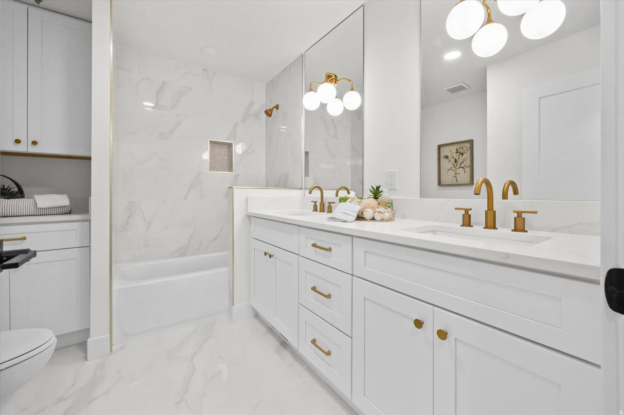 Dual vanity with quartz countertop, undermount sinks, and brushed gold fixtures