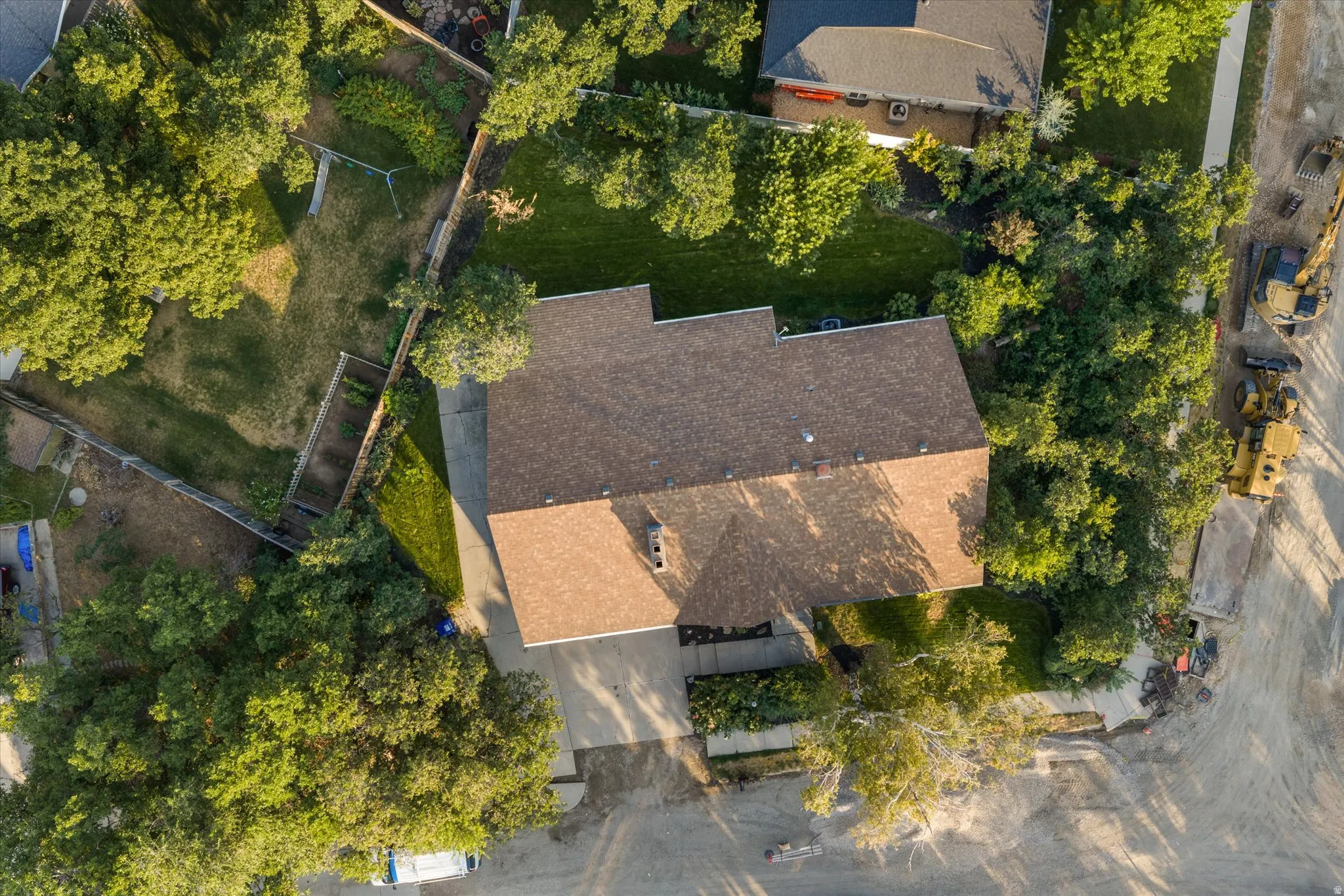 Property with a brown shingle roof and an attached garage