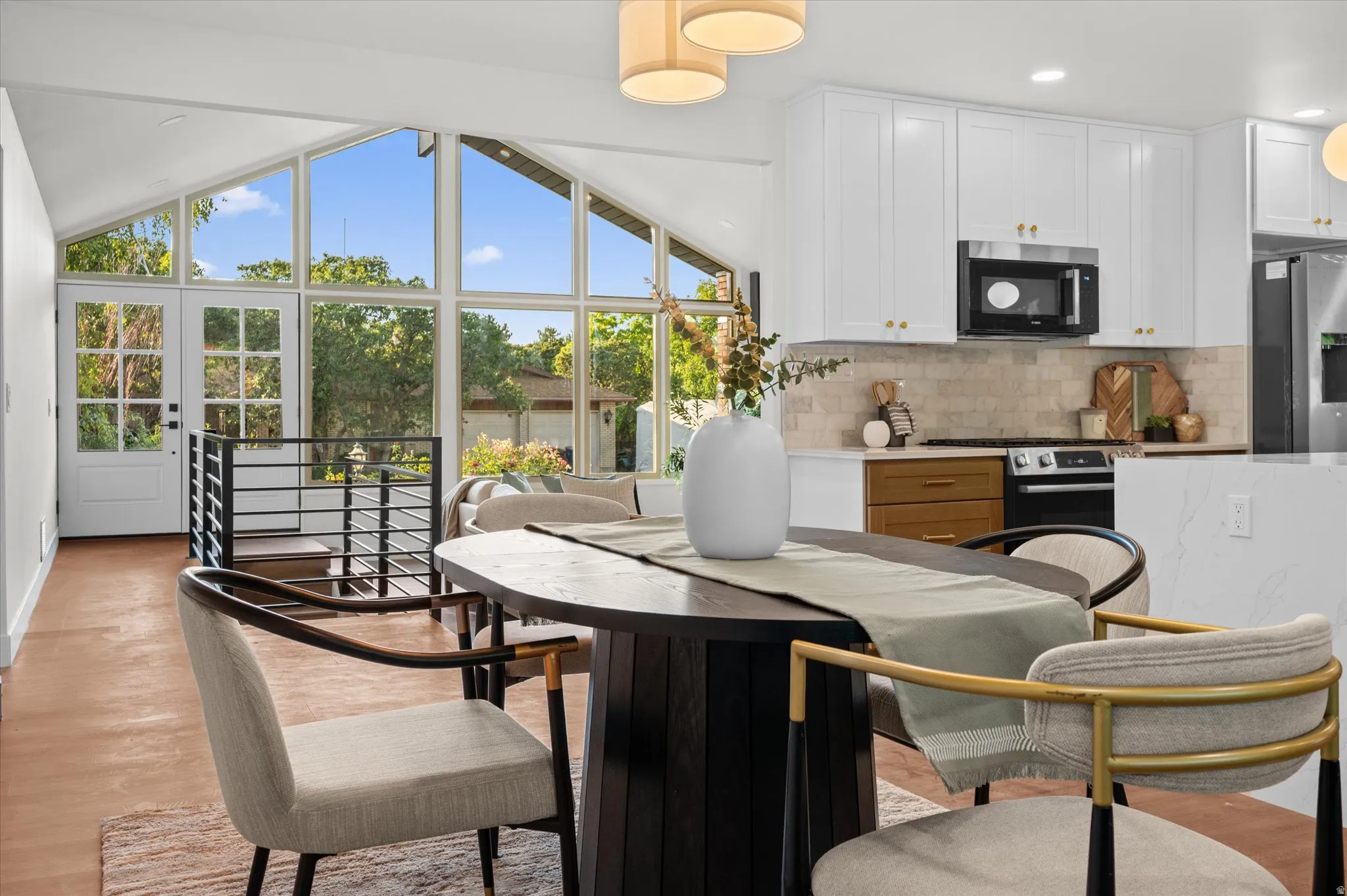 Expansive living area with vaulted ceilings and floor-to-ceiling windows