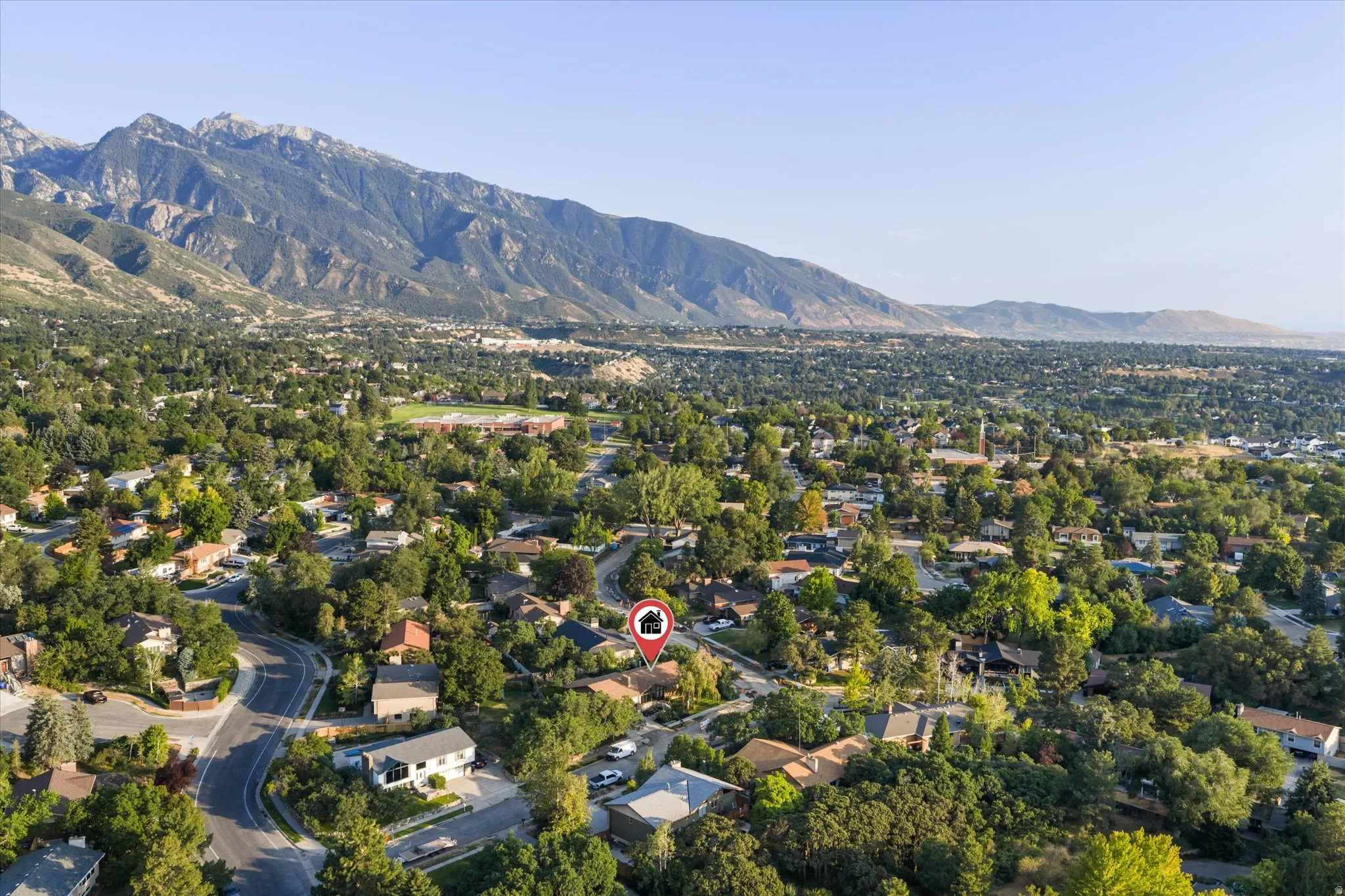 Expansive aerial view showcasing a residential area with mature tree coverage