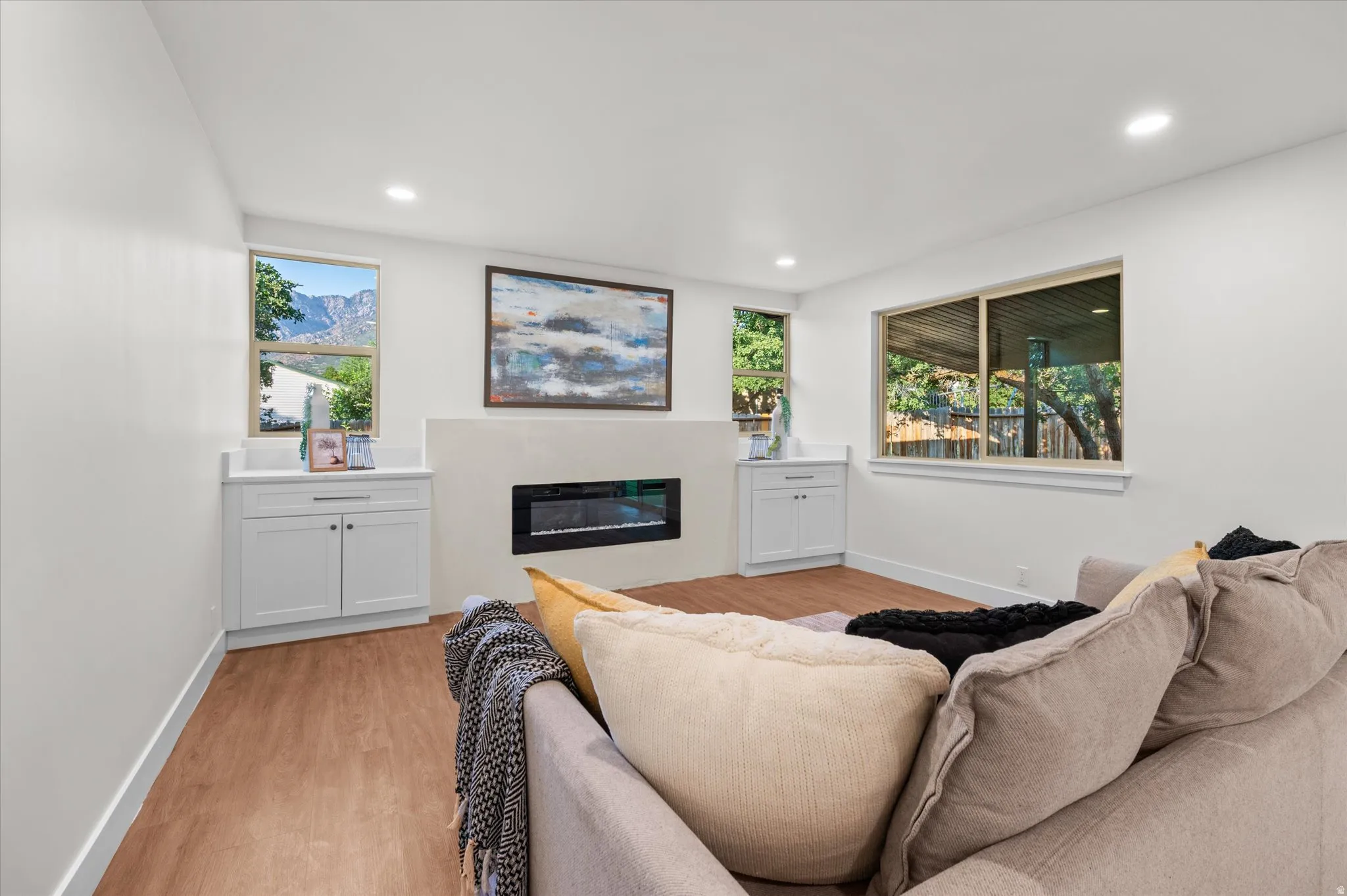 Living area featuring wood-finish flooring and recessed lighting