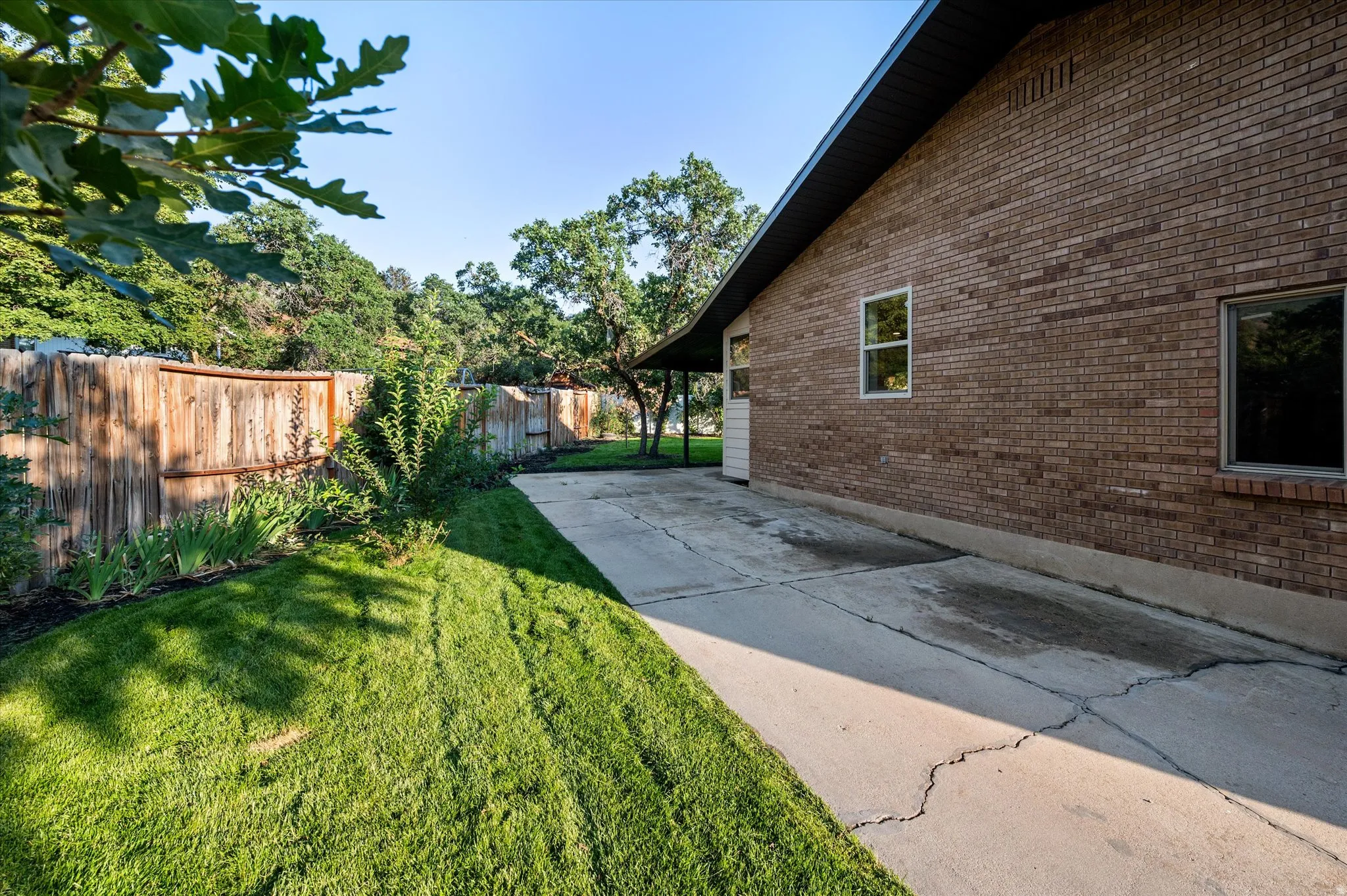 Brick exterior with dark soffits and fascia, featuring multiple windows