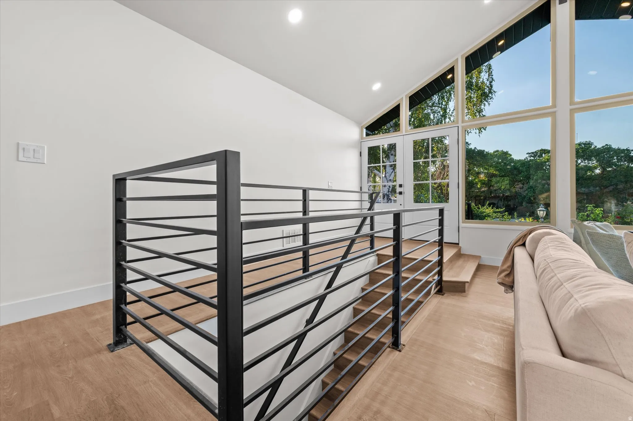 Modern black metal horizontal railing system with wood-finish flooring