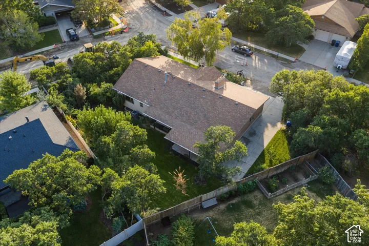 Residential property featuring a brown shingle roof and a concrete driveway
