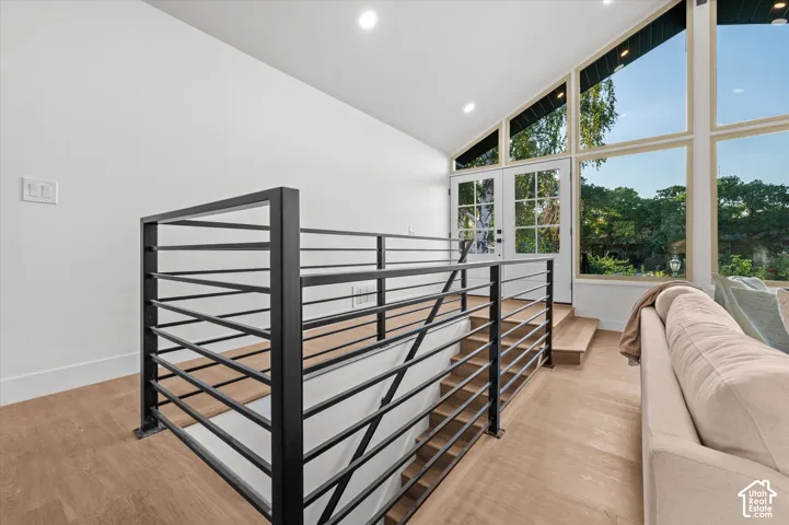 Modern black metal horizontal railing system with wood-finish flooring
