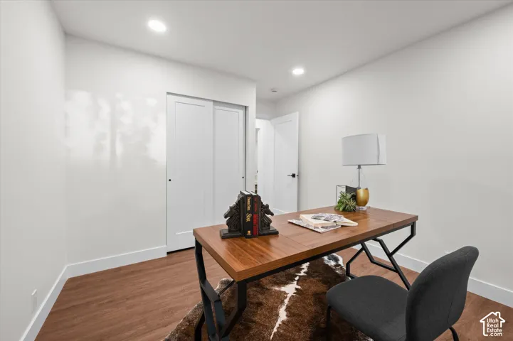 Versatile room featuring wood-finish flooring and recessed lighting
