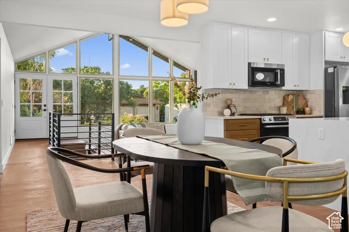 Expansive living area with vaulted ceilings and floor-to-ceiling windows