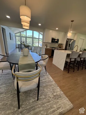 Open-concept living space with wood-finish flooring