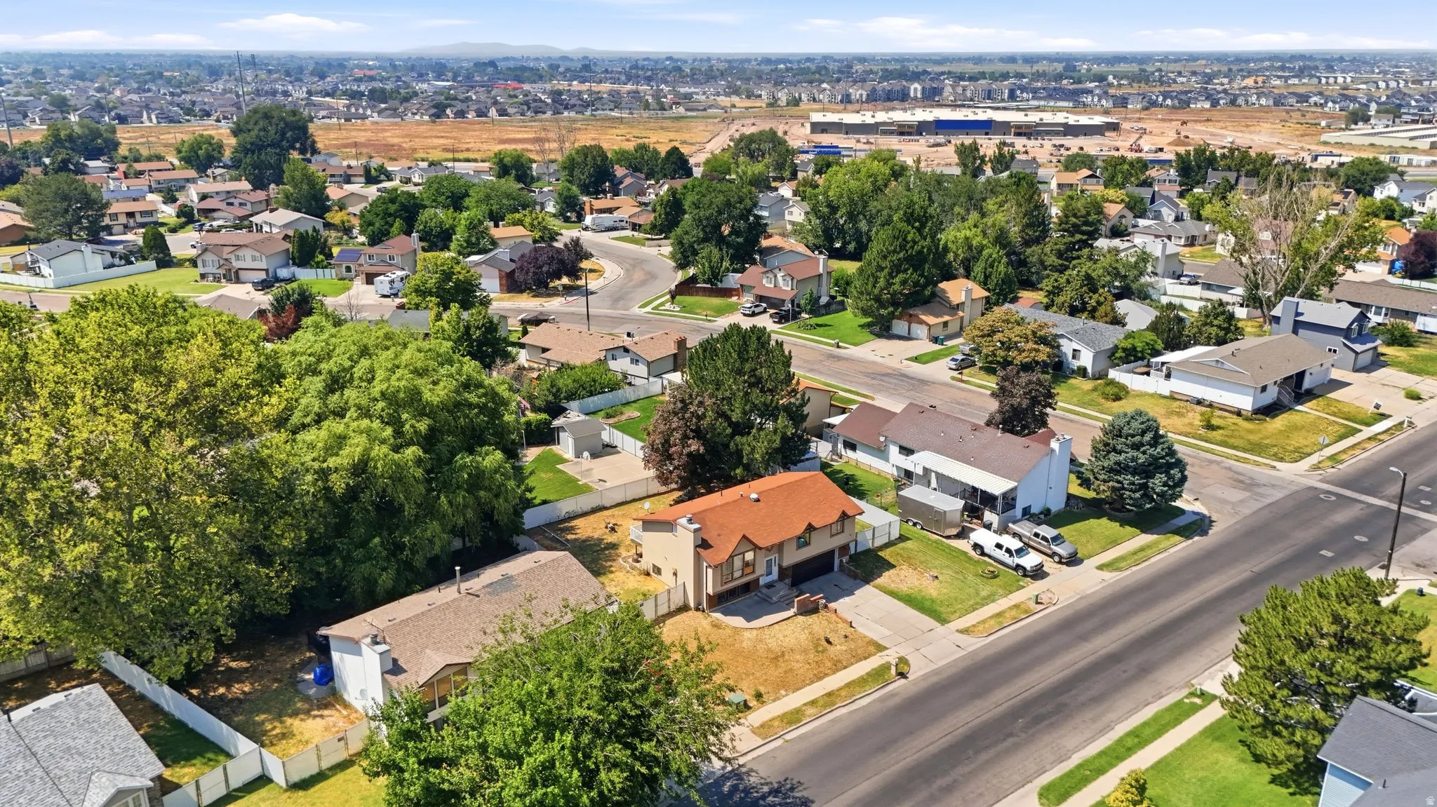 Charming brick residence set on a spacious corner lot with mature landscaping and established trees throughout the neighborhood
