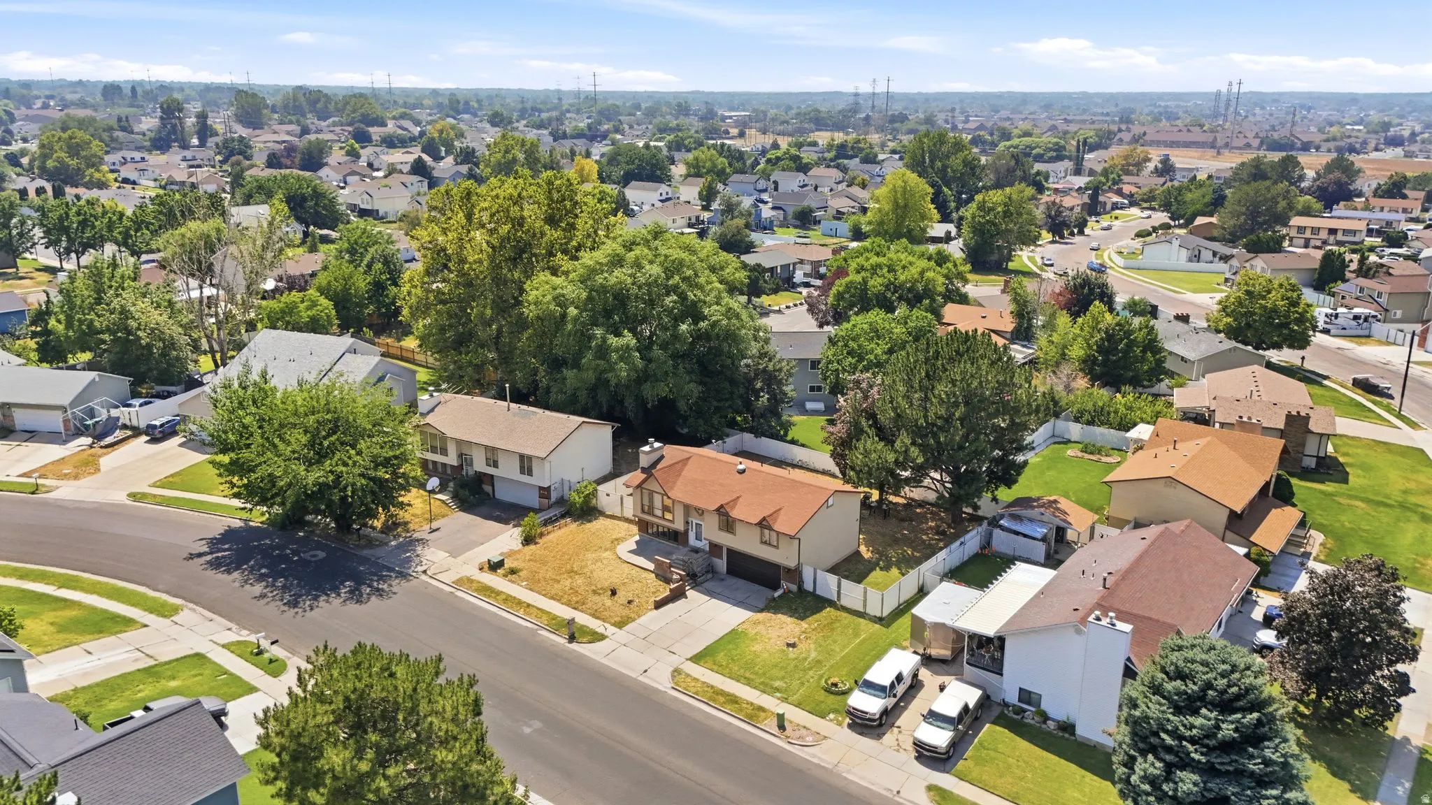Neighborhood featuring mature trees, residential streets, and a mix of roof styles