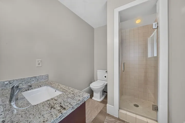Vanity with granite countertop, integrated sink, and chrome faucet