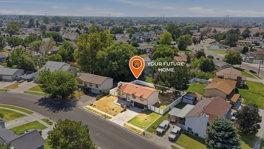 Multi-level residential property with an attached garage, a paved driveway, and a fenced backyard