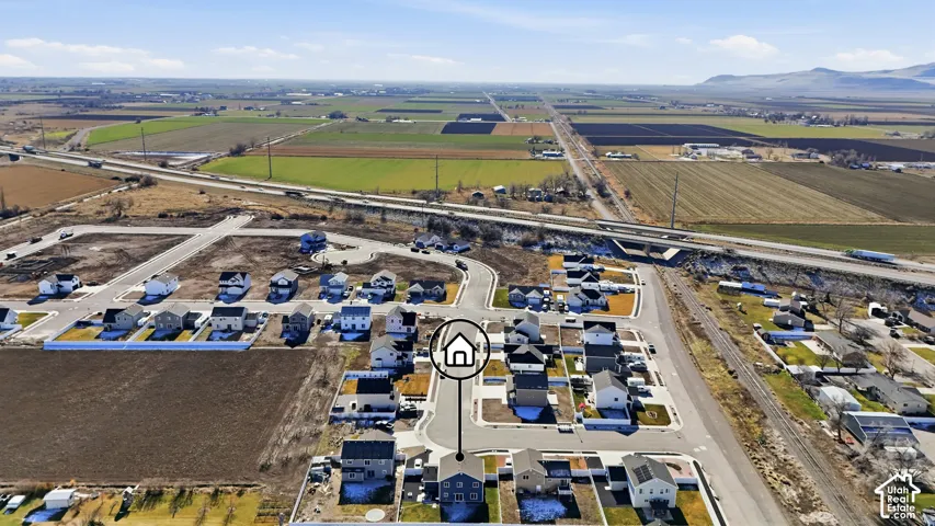 Aerial perspective of a developing residential area with established homes and new construction sites