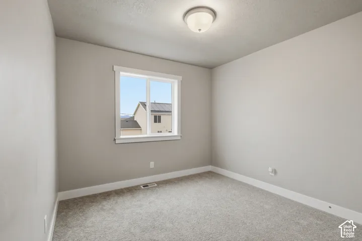 Neutral wall tones with white trim, carpeting, and a double-pane window