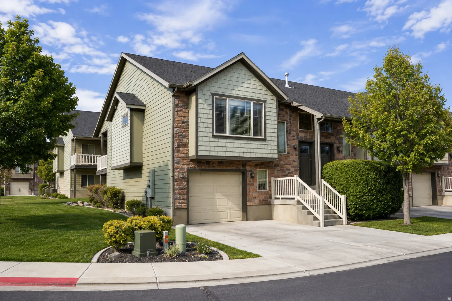 Exterior featuring stone veneer and horizontal siding with shaker-style accents