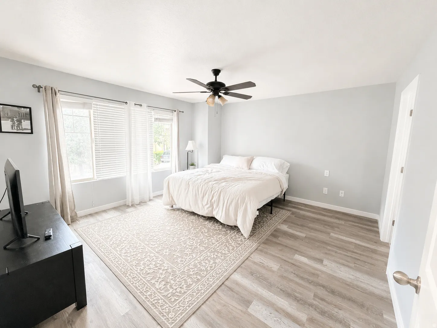 Room with light gray walls and wood-finish flooring
