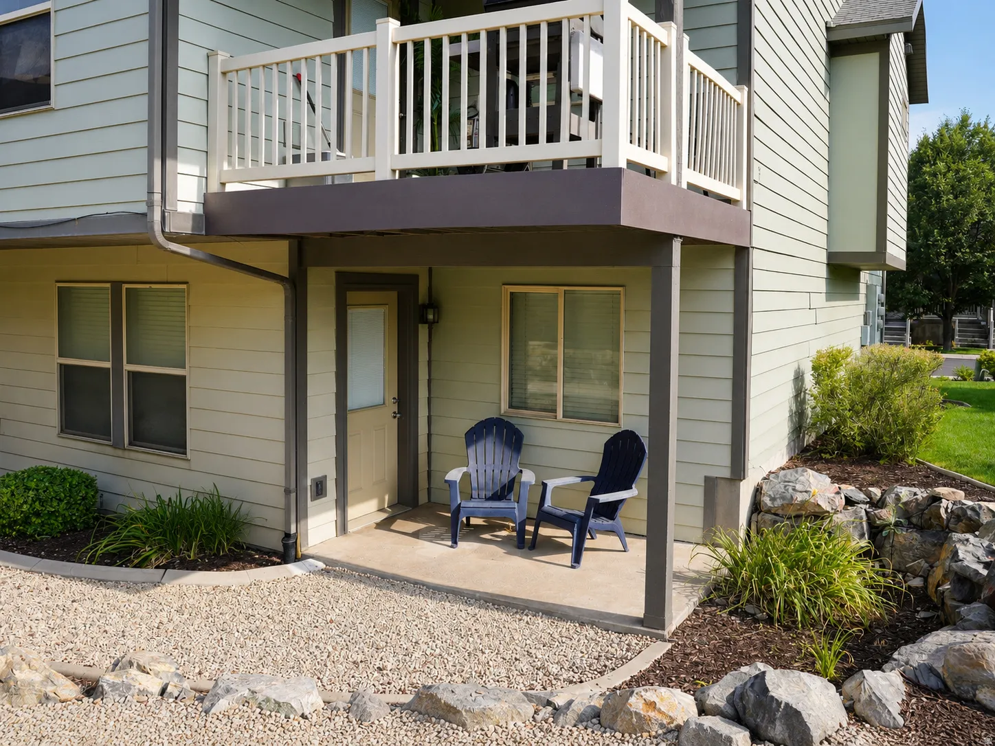 Covered patio area with concrete flooring, accented by a gravel perimeter