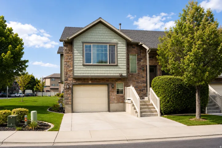 Two-story residence featuring stone and shingle siding