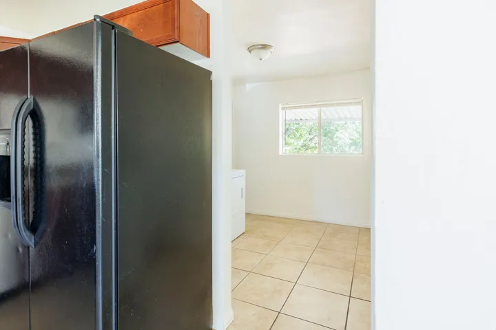 Kitchen refrigerator with overhead cabinetry